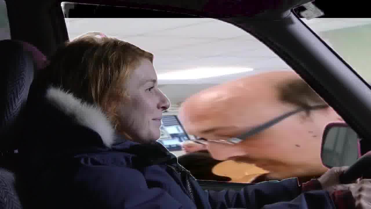 Female driver enjoys man flashing outside of car