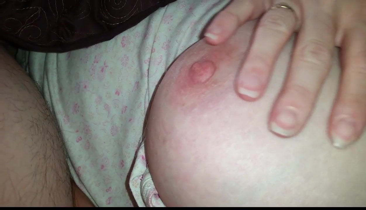 wife pinching her left nipple