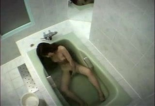 Japanese girl rubs her clit in bathtub