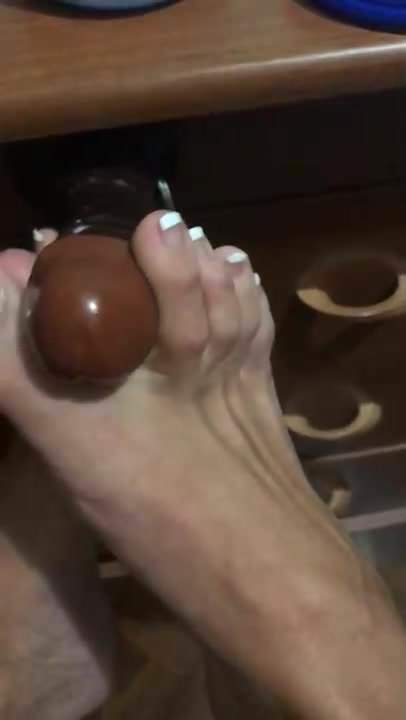 Sissy Britney stroking a black dildo with her feet