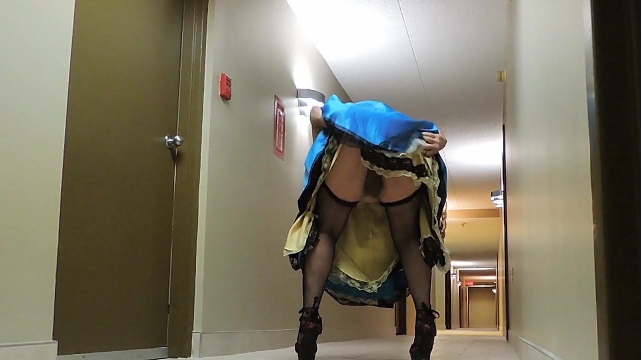 Sissy Ray in Blue Satin Dress in Corridor of Hotel