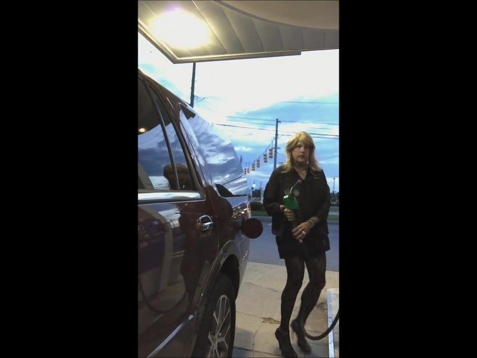 Gassing up in mini-dress