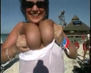 Brunette flashing huge boobs on beach