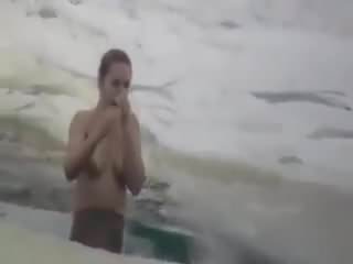 Hot russian woman bathes in the ice-hole