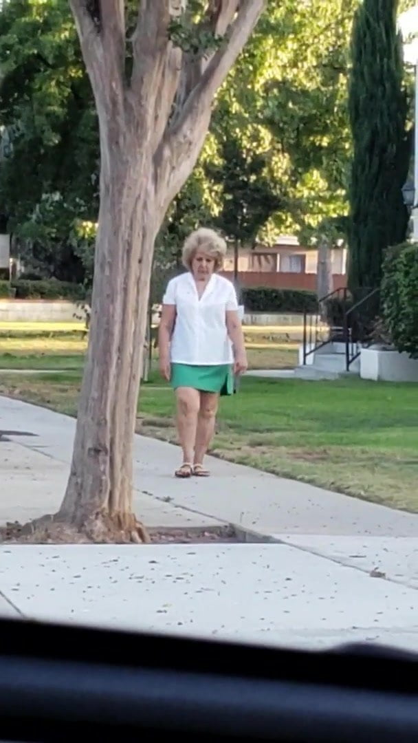 Candid street granny in short skirt