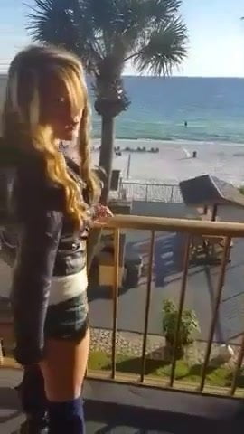 Girl plays with toy on balcony