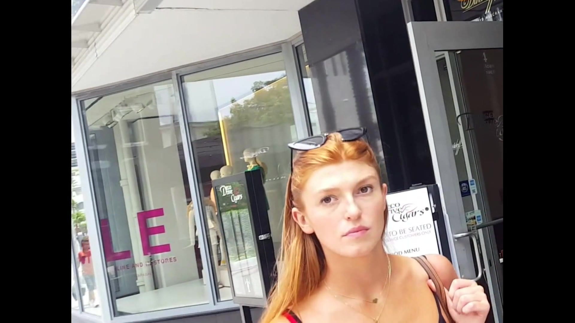 Candid voyeur gorgeous redhead model in skirt shopping