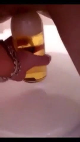 Girl fucks herself with beer bottle