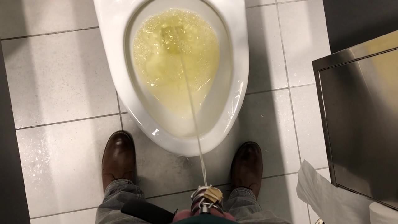 Chastity piss in a public stall