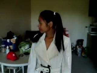 Asian in white PVC coat pants and boots