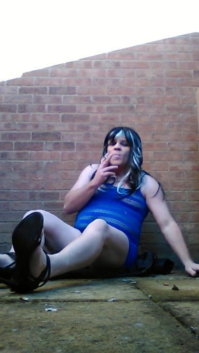 Sissy smoking outdoors in sexy dress