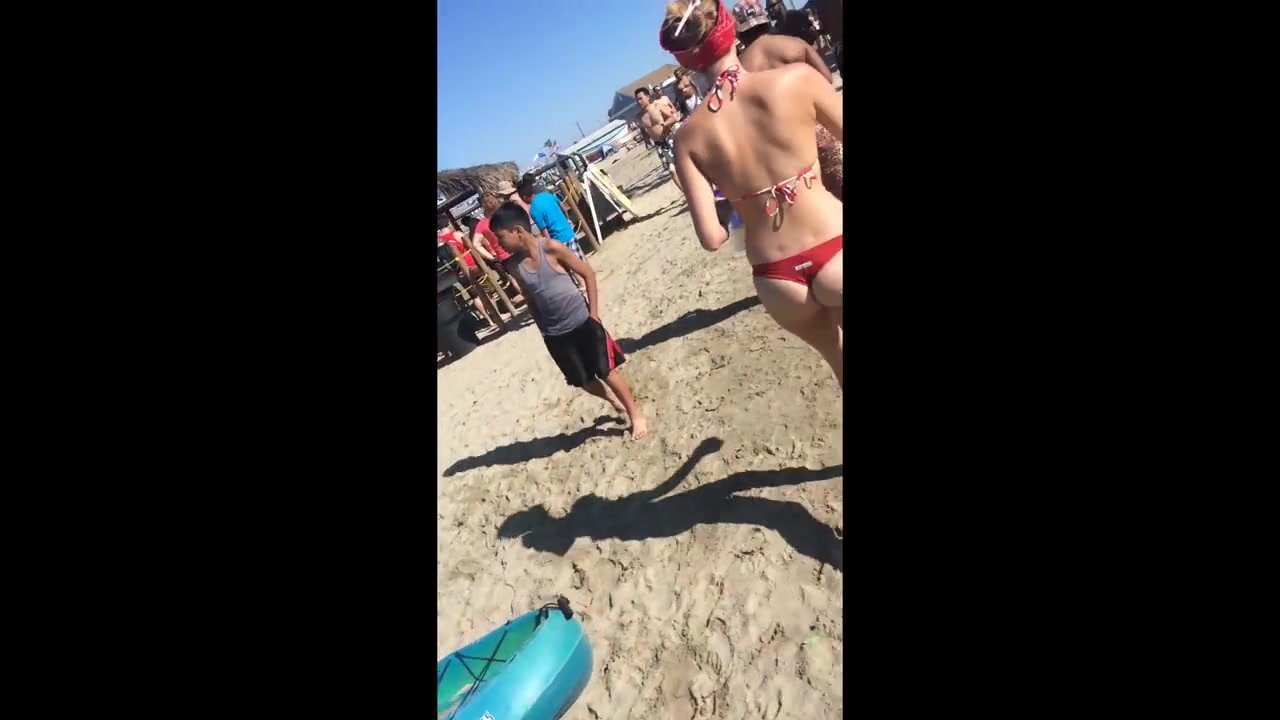 Fit teen in red bikini on the beach