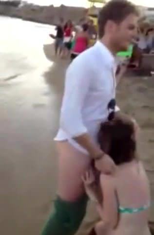 American girl sucking dick at a beach party