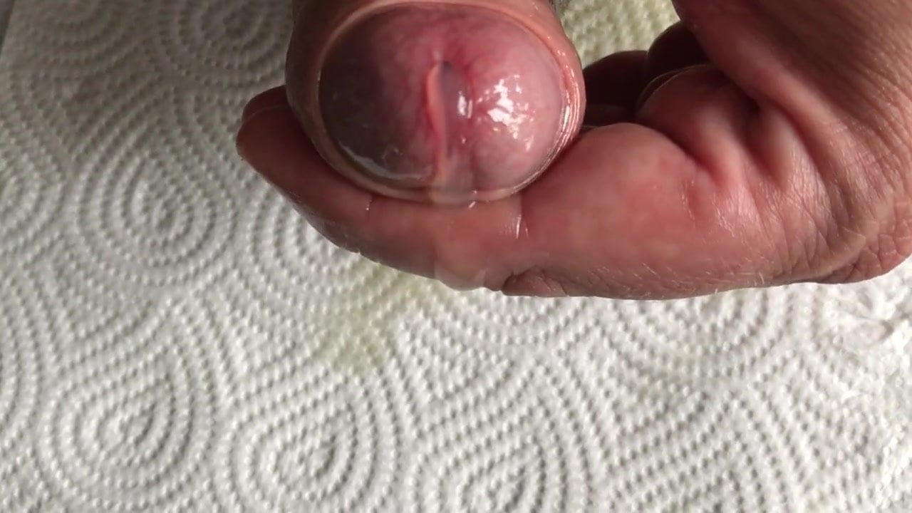Closeup - Cum flows slow out of my oiled cockhead