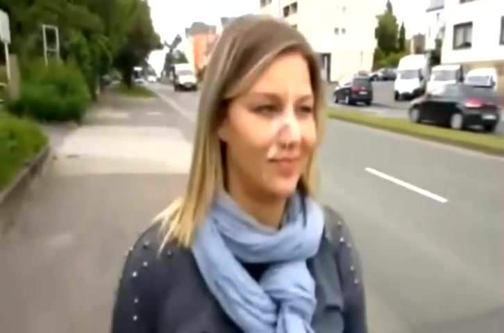 Blonde woman walking by the road with a cumshot on her face