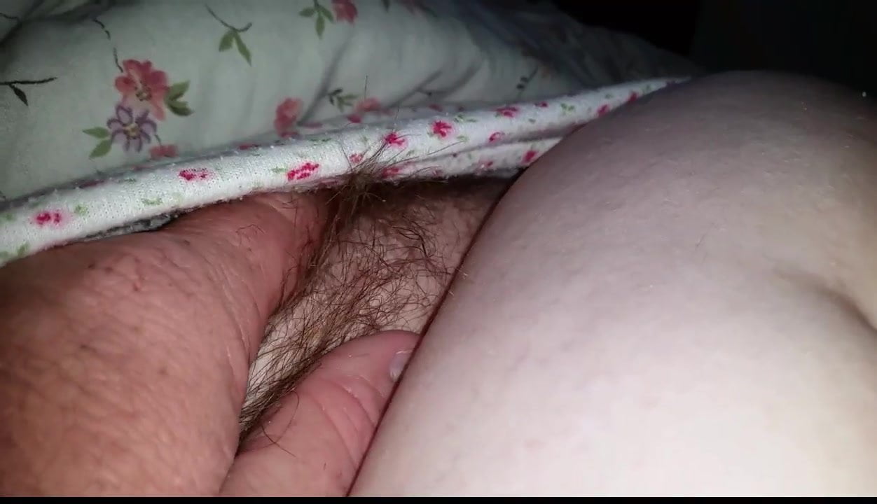 rubbing her tired soft belly, hairy pussy in her jammies.