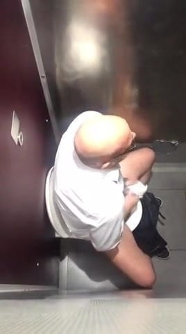 Spying on hot daddy jerking off in the men's room