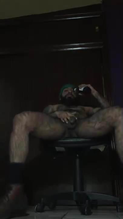 Hot hairy guy drinks beer and pisses  while jerking cock 
